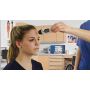 Front view of the School Health portable infrared temperature thermometer no touch; medical thermometer held towards a patients forehead by a physician in a school nurse office.   thumbnail