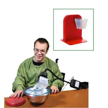 Student using pouring cup on flex mount at a table; displayed with a pouring cup on stand pictured on the top corner.