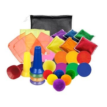 A collection of colorful physical education equipment; including bean bags; cones; scarves; ubber spots; textured balls; and a mesh storage bag.