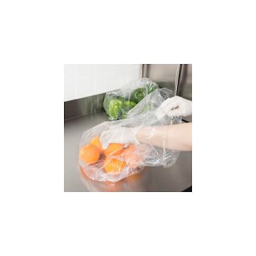 Person putting oranges into 0.75mil, 10x8x24 Large Clear Poly Bag with 500 bags per case