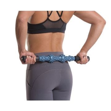 Woman using RM Extreme Rollers on her back