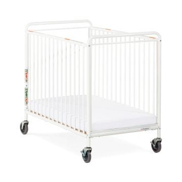 the chelsea compact white metal evacuation crib with clearview end panels and mattress board adjusted to the lowest height position