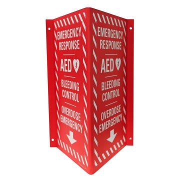 A bright red combo emergency response cabinet sign with clear white lettering. The sign indicates that an AED; bleeding control tools; and overdose emergency tools are available below; using a directional down arrow. Front view shows both sides.