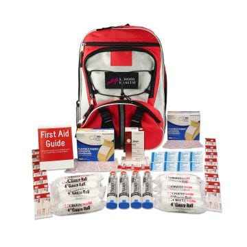 Red & grey backpack with School Health logo on black patch. First aid supplies laid out in front of backpack.