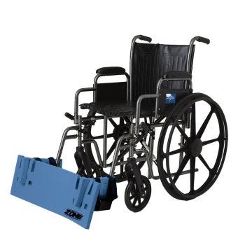 A rectangular blue pad attached across the front lower footrests of a standard manual wheelchair.