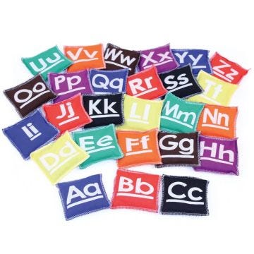 A colorful collection of small fabric beanbags; each displaying a letter of the alphabet in both uppercase and lowercase.