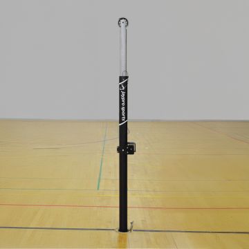 A Hybrid Steel Volleyball Uprights, showcasing a sturdy design with a sleek finish. Positioned in a gym setting with hardwood floors.