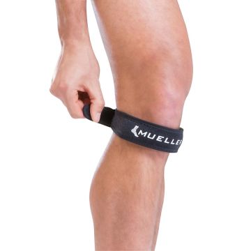 A black Mueller knee strap with the Mueller logo written in white wrapped around a leg.