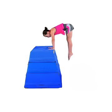 A young female gymnast preparing a handstand atop a 3-layer blue gymnastics trapezoid.