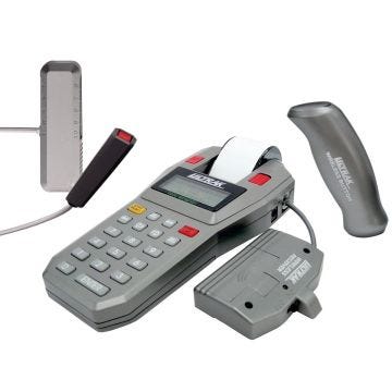 A close-up view of a timer system featuring a handheld digital timer, a wireless button, and accompanying hardware in gray and black