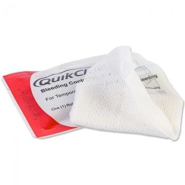 Front view of 3" x 4 ft QuikClot Bleeding Control Roll Dressing on top of package