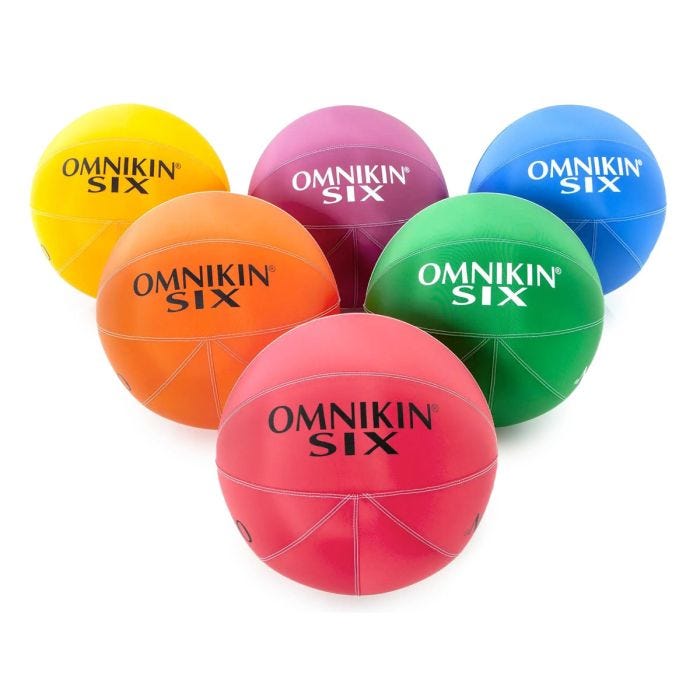 Six different colored balls with OMNIKIN SIX written in large black lettering on the yellow, orange, and red ball. White lettered OMNIKIN SIX written on the purple, green, and blue. Six different colored balls with OMNIKIN SIX written in large black lettering on the yellow, orange, and red ball. White lettered OMNIKIN SIX written on the purple, green, and blue.