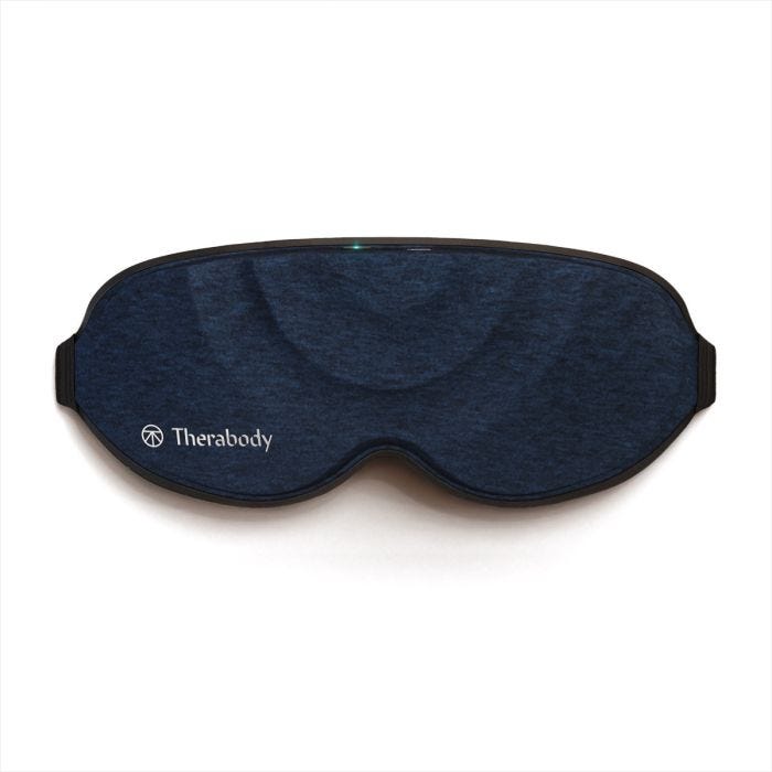 Navy colored Therabody SleepMask that is shaped like a normal sleep mask to fit over the eyes and around the nose. Navy colored Therabody SleepMask that is shaped like a normal sleep mask to fit over the eyes and around the nose.