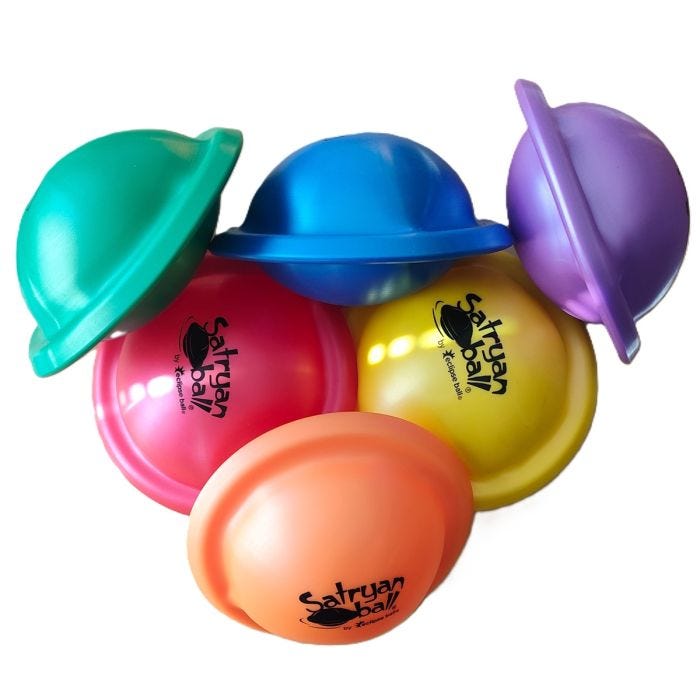 A set of colorful Saturn shaped balls in red, yellow, orange, blue, green, and purple. Each ball has a ringed, dome-like shape with the "Satryan Ball" logo printed on the surface. A set of colorful Saturn shaped balls in red, yellow, orange, blue, green, and purple. Each ball has a ringed, dome-like shape with the "Satryan Ball" logo printed on the surface.