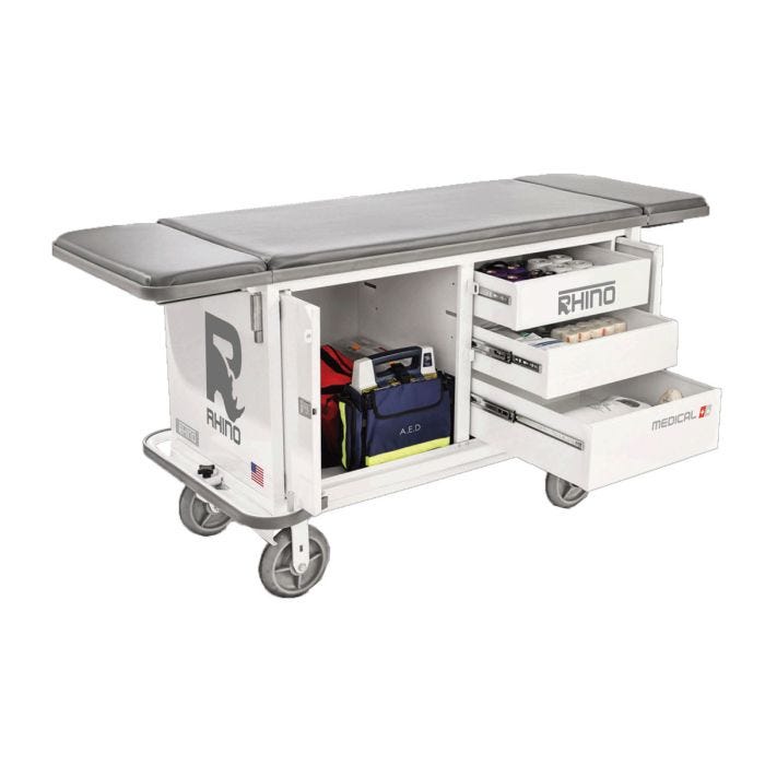 White, steel medical cart with gray padding and sturdy wheels. Three cabinet drawers on the right side and large cabinet on the left. White, steel medical cart with gray padding and sturdy wheels. Three cabinet drawers on the right side and large cabinet on the left.