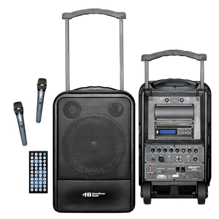 Front, speaker side, of the PA system is shown, as well as the back side. Back side shows knobs and buttons for operation. A pull handle is shown sticking out of the top. A push button remote control and 2 wireless microphones are also shown. Front, speaker side, of the PA system is shown, as well as the back side. Back side shows knobs and buttons for operation. A pull handle is shown sticking out of the top. A push button remote control and 2 wireless microphones are also shown.