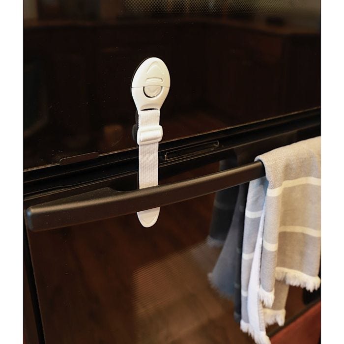 White adjustable appliance safety lock securely fastened on a black appliance ensuring safety and preventing unauthorized access. White adjustable appliance safety lock securely fastened on a black appliance ensuring safety and preventing unauthorized access.
